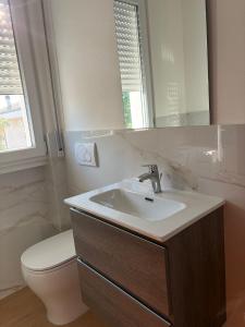 a bathroom with a sink and a toilet and a mirror at Casa sole cuore amore in Torre del Lago Puccini +9 photos