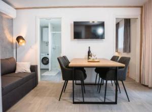 a living room with a table and chairs and a couch at Lux Mobile Homes Vodice in Vodice