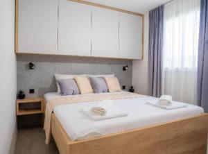 a bedroom with a large bed with white cabinets at Lux Mobile Homes Vodice in Vodice