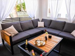 a living room with a couch and a table at Lux Mobile Homes Vodice in Vodice