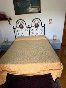 a bedroom with a large bed with a bedspread at La casa dei Nonni in Romagnese