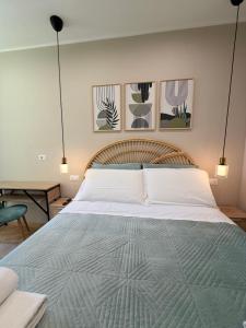 a bedroom with a large bed and three pictures on the wall at Velvet Rooms Florence in Florence