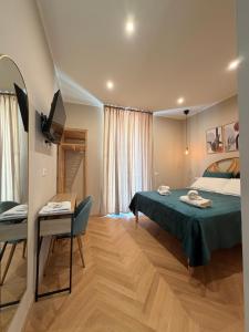 a bedroom with a bed and a table and a chair at Velvet Rooms Florence in Florence