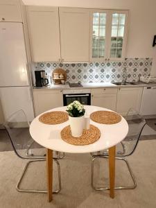 a white table with a potted plant on it in a kitchen at Kinnekulle bed & breakfast in Källby +12 photos