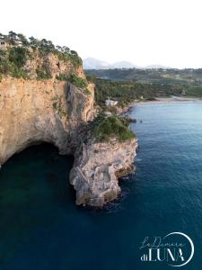 an aerial view of a rocky coastline with the ocean at La Dimora di Luna in Terrasini