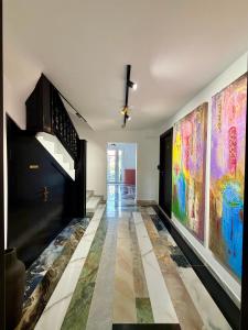 a hallway with colorful paintings on the walls at Eclectic 6 in Satu Mare
