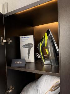 a shelf with a pair of scissors and a box at Salo Pool Hotel by the Sea in Gonio