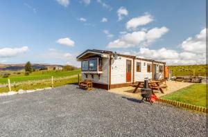 a small house with a picnic table and a bench at Attymchugh Lodge in Corlee