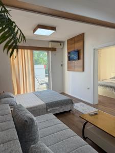 a living room with a bed and a couch at Ajan Apartments in Ulcinj