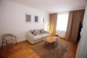 a living room with a couch and a table and a chair at Jessop Haus in Lübeck
