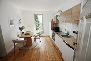 a kitchen with a table and a small table and chairs at Jessop Haus in Lübeck