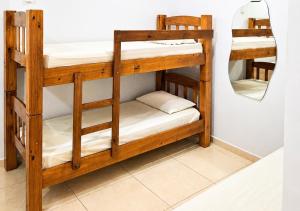 a pair of bunk beds in a room with a mirror at IMPERIAL BEACH ENSEADA 500 Metros Praia Enseada Gjá Av Professor João Batista Julião x Antonio Del Nero Enseadas jardim Virgínia Bairro Nobre in Guarujá