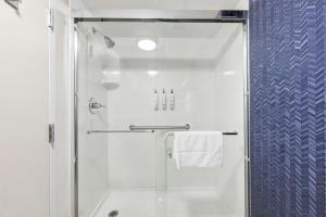 a bathroom with a shower with a glass door at Fairfield by Marriott Inn & Suites Wallingford New Haven in Wallingford +25 photos