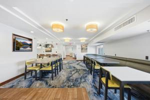 a dining room with tables and yellow chairs at Fairfield by Marriott Inn & Suites Wallingford New Haven in Wallingford