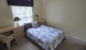 a small bedroom with a bed and a window at Accessible-Friendly Pool Retreat Extended Stay Welcome in Valrico +22 photos