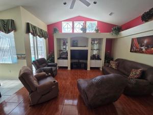 a living room with two couches and a tv at Accessible-Friendly Pool Retreat Extended Stay Welcome in Valrico