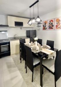 a kitchen with a dining room table and chairs at Entire House with Parking, Full Kitchen and Near SRP, Seaside and Nustar in Talisay