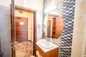 a bathroom with a sink and a mirror at Hotel Ryon Mamaia-Nord in Mamaia Sat/Năvodari +50 photos