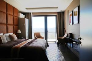 a hotel room with a bed and a desk and a window at Quinta de Raj - Your Douro Valley Retreat in Peso da Régua +62 photos