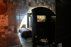 a bathroom with a mirror and a bed in a room at Quinta de Raj - Your Douro Valley Retreat in Peso da Régua