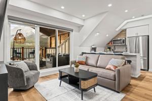 a living room with a couch and a table at Golden Ridge Collection in Canmore