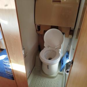 a bathroom with a toilet in a small room at Caravane in Port-sur-Saône