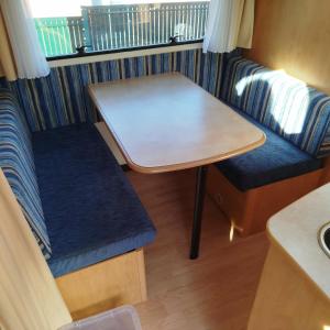 a small table and chairs in a caravan at Caravane in Port-sur-Saône
