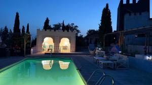 a swimming pool at night with a building at Torre Calera in Arganda del Rey