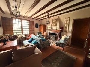 a living room with a couch and chairs and a fireplace at Torre Calera in Arganda del Rey