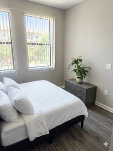 a bedroom with a bed and a potted plant at King Aqua Suite Walkable Legacy West King Bed, Pool & Gym in Plano +29 photos