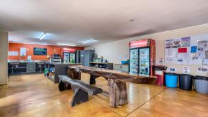 a store with a bench in the middle of a room at Beachcomber Lodge & Backpacker in Kaitaia