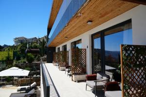 a row of chairs and tables on a patio at Quinta de Raj - Your Douro Valley Retreat in Peso da Régua