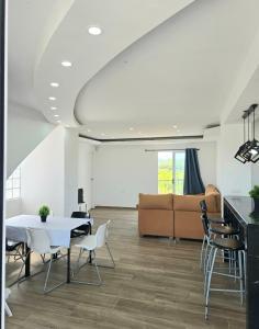 a living room with a table and chairs and a couch at Villa Los Naranjos in Carcaixent
