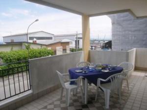 a blue table and chairs on a balcony at Zancan Appartament in Grado