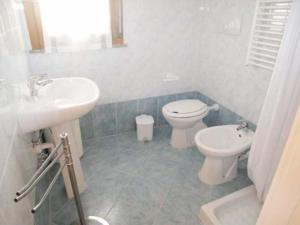 a bathroom with a toilet and a sink at Zancan Appartament in Grado
