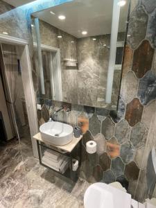 a bathroom with a sink and a toilet and a mirror at Dionisia Apartments in Kefalos +34 photos