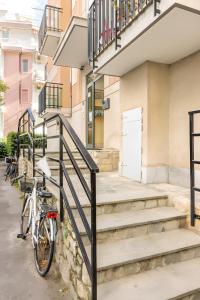 a bike parked in front of a building with stairs at Blu Marina Alassio in Alassio