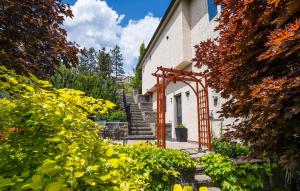 a house with an archway in a garden at Sunrise Valley Suite in West Kelowna