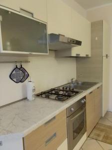a kitchen with a stove and a sink at Casa al parco in Romano D'Ezzelino