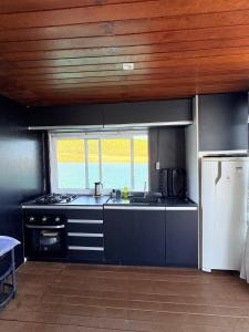 a kitchen with a sink and a refrigerator at House Boat in Capitólio