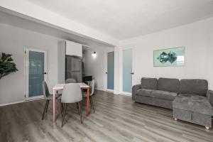 a living room with a couch and a table at Balandras Beach Stay 1 Beach & Pool Access in Dorado