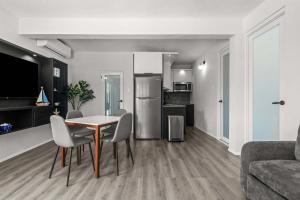 a kitchen and living room with a table and chairs at Balandras Beach Stay 1 Beach & Pool Access in Dorado
