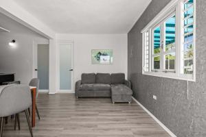 a living room with a couch and a window at Balandras Beach Stay 1 Beach & Pool Access in Dorado