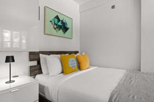 a white bedroom with two beds and a night stand at Balandras Beach Stay 3 Beach & Pool Access in Dorado +38 photos