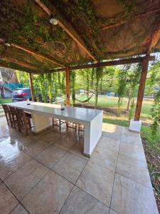 a white table and chairs on a patio at Harvestmoon Boutique Hotel in Las Piedras