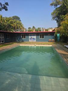 a pool of water in front of a house at Harvestmoon Boutique Hotel in Las Piedras