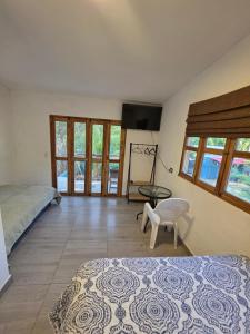 a bedroom with a bed and a table and a chair at Harvestmoon Boutique Hotel in Las Piedras +23 photos