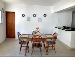 a dining room with a wooden table and chairs at Hospedaje Las Moreras-Vaqueros in Vaqueros