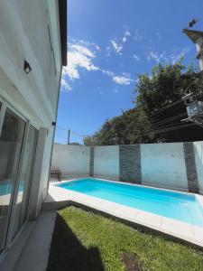 a swimming pool sitting next to a house at Hospedaje Las Moreras-Vaqueros in Vaqueros