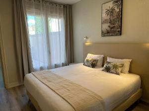 a bedroom with a large bed with a window at Hotel Chiffre in Albi